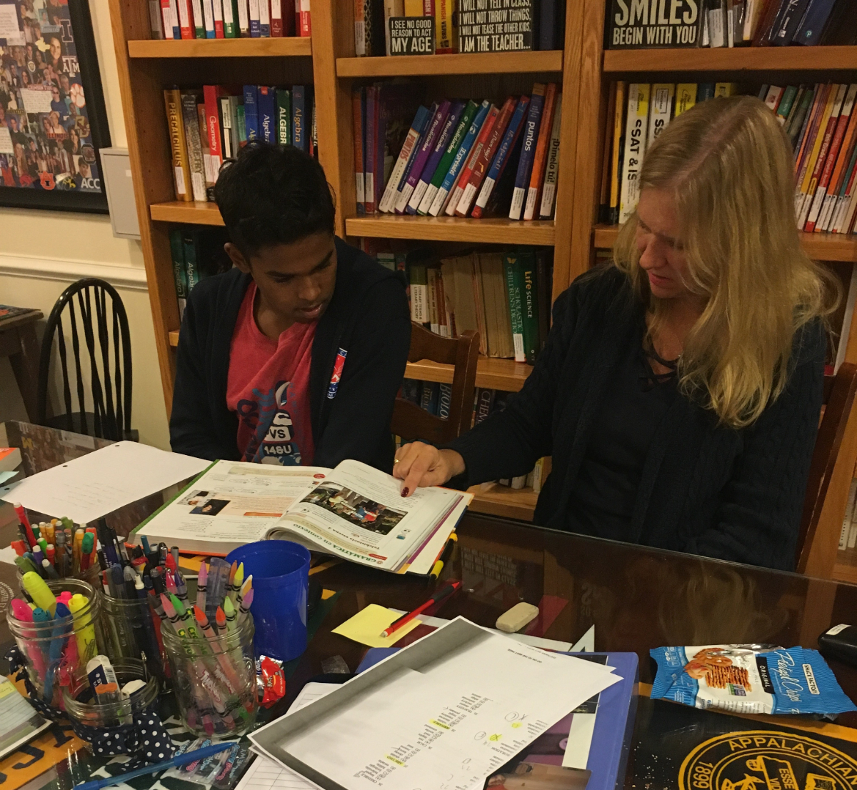 Julia Ross tutors a group of high school students at the Professional Tutoring Cottage.