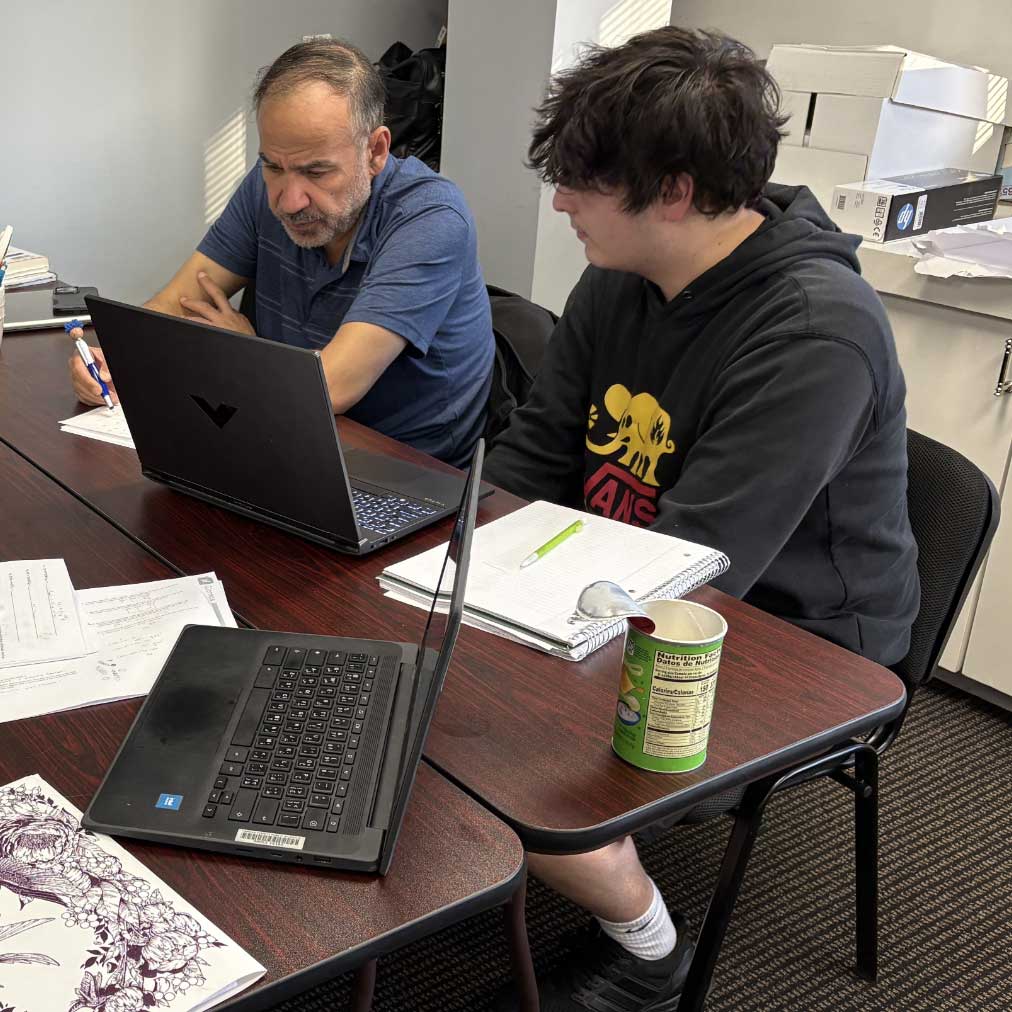 Julia Ross tutors a group of high school students at the Professional Tutoring Cottage.