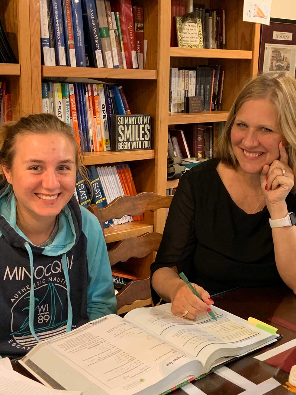 Julia Ross tutors a group of high school students at the Professional Tutoring Cottage.